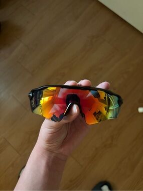 Oakley Black Frame Sunglasses with Red-Orange Mirrored Lens